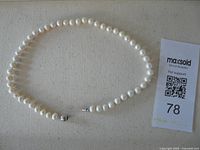 Full view of pearl necklace laid flat
