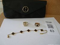 Overview of cosmetic case, two rings, and bracelet