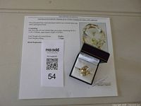 Ring in presentation box with documentation sheet visible