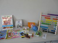Group shot of all items: books, abacus, craft kits, toys