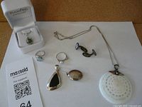 Group shot of entire jewelry lot with cufflinks, pendants, chain and rings