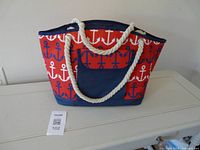 Full view of tote showing anchor pattern, rope handles, front pocket