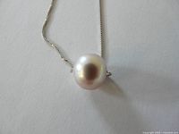 Close-up of pearl on chain