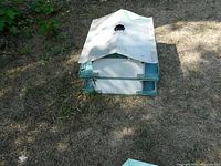 disassembled or second bird house top view showing roof panel and tray
