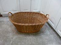 Angled view of wicker basket showing overall form and handles