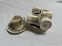Full set of six cups and six saucers with one cup on saucer, mark visible on bottom