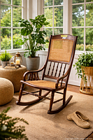 Front view showing intact cane seat and back, spindle detailing, overall wear