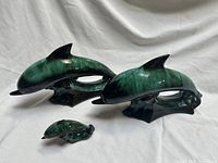 Front view of all three graduated dolphin figures