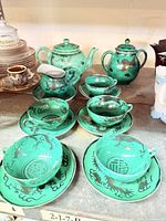 Full set overview showing teapot, sugar, creamer, cups and saucers