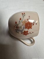 side view of teacup showing floral motif and handle