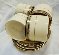 Close-up of cups showing rim pattern and saucers