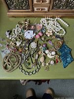 Overview of entire mixed jewelry lot on table