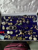 Overview of jewellery tray showing assorted earrings, cufflinks and brooches