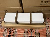 Front view of LED vanity light resting on box