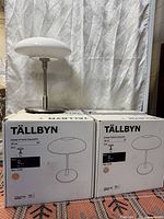 Lamp assembled beside two TÄLLBYN boxes