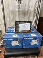 Front view of boxed Heath/Zenith HZ-5505-BZ light with instruction sheet visible