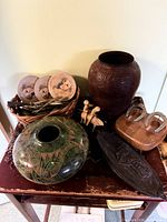 Group shot of entire lot on table showing bowl, vase, horseshoe art, coasters, canoe dish, figures