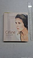 Book front cover showing a large photo of Céline Dion wearing headphones with the title 'Céline: Beyond the Image'.