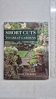 Front cover of the hardcover gardening book showing garden imagery and title.
