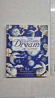Front cover of 'The Illustrated Dream Dictionary' book showing detailed celestial artwork and title.