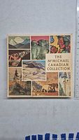 Front cover of the McMichael Canadian Collection art book showing various Canadian artworks in a collage style with title text.