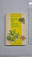 Front cover of paperback book with illustrated house plants and title