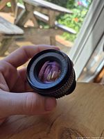 Front view of the vintage Takumar camera lens showing the lens glass and brand text around the glass
