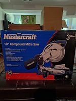 Front of Mastercraft box showing 10" compound mitre saw graphic and key features