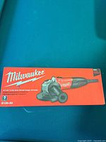Front view of Milwaukee 4.5 inch small angle grinder box showing product image and model number 6130-33, emphasizing size and brand.