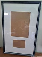 Full view of wooden picture frame with mat showing openings for an 8.5 x 11 document and 4 x 6 photo