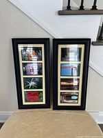 Photo of two vertical black wooden picture frames with multiple openings for photos, placed on floor against a wall. The larger frame has five openings and the smaller frame has four openings. Beige mats inside, images placed inside. Both frames appear in good condition.