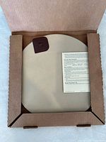 Round pizza stone packed in original box with instruction card.