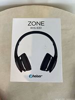 Front of original box showing black on-ear headphones with Phaiser branding and model ZONE BHS-630