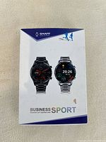 Front of the box showing image of two smartwatches labeled Business Sport with Bluetooth call and stainless steel band.