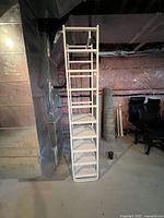 Full front view of the white IKEA shelf showing its tall, narrow structure with eight open cube compartments.