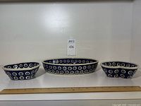 Front view of the three Polish porcelain dishes with ruler for size reference.