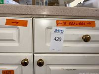 Photo of kitchen drawers indicating 3 drawers included in lot.