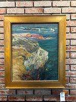 Full view of framed canvas painting showing coastal landscape with rocky cliff and sailboats