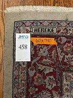 Corner close-up showing 'Hereke' maker label and orange size sticker