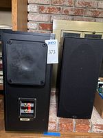Pair of Polk Audio RT55 bookshelf speakers with visible front grille and rear panel with connection terminals and model label.