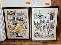 Two framed illustrated prints side by side against wood background.