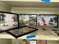 Four framed Asian landscape prints with traditional boats and houses, laid out with the fabric square in view