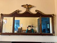Mounted full mirror on wall showing scale and condition.