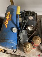 Top view of blue AirMate by Emglo compressor showing tank, handle and accessories