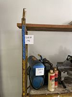 Side view of yellow Bil Jax scaffold frame showing vertical post, paint wear