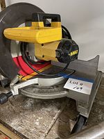 Left-front view showing Dewalt branding, blade, table and miter gauge