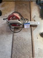 Top view of Milwaukee circular saw on plywood base with guide rail