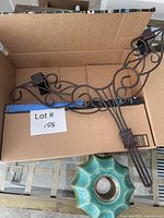 Iron scroll hanger and teal ceramic fire pot inside box