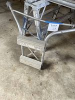 Full view of ladder stabilizer attached to ladder showing overall form