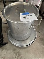 Tall Tablecraft pot stacked on shorter Priscillaware pot, both with lids